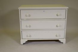 A painted pine chest of three long drawers, raised on bracket supports, 36" x 17" x 30"