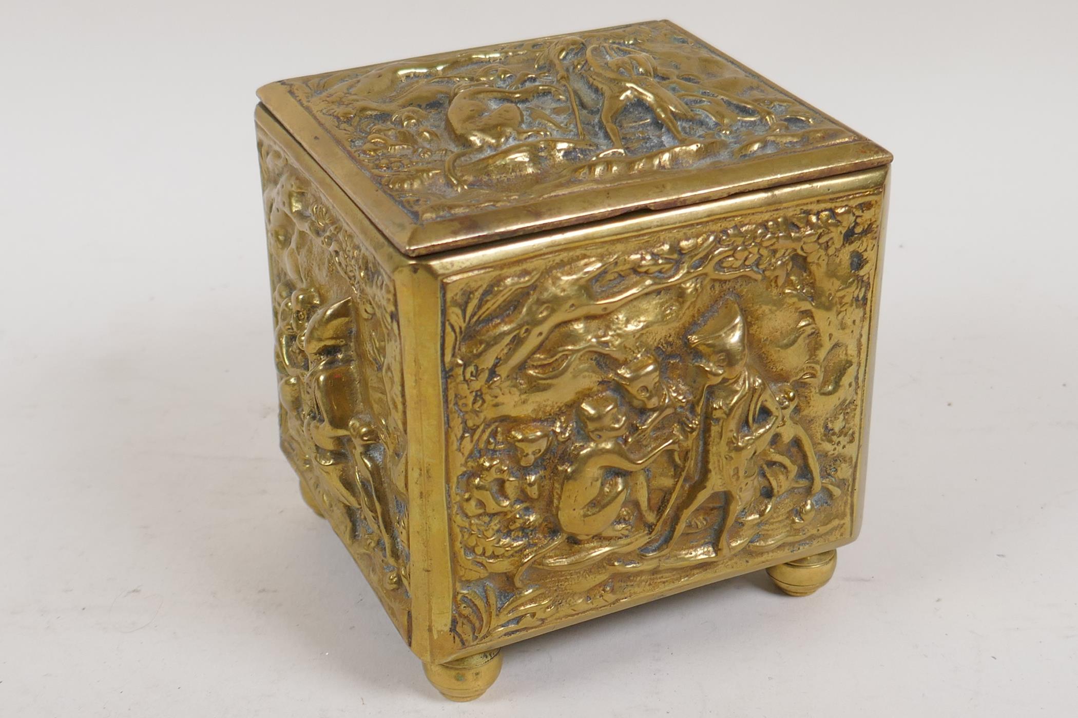 A late C18th/early C19th Dutch brass tobacco box embossed with a scene of a travelling monkey