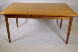 A mid century teak dining table with pull out leaves, 36" x 58" x 106"