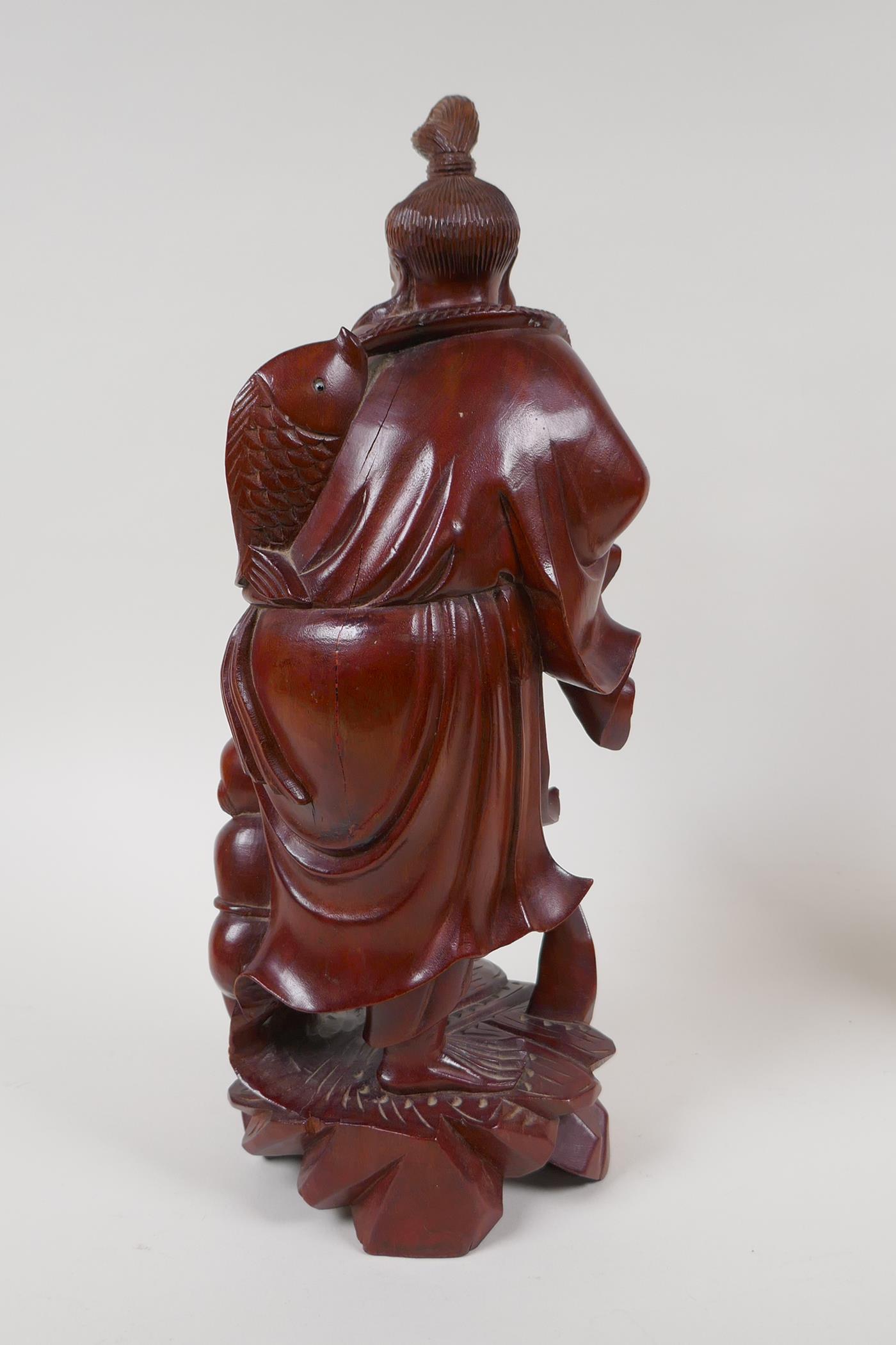 A Japanese hardwood carving of a fisherman, and a Balinese hardwood carving of a man in - Image 3 of 6