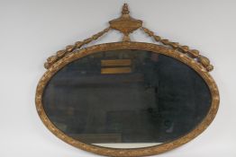 A gilt framed Adam style oval wall mirror, 23½" x 20"