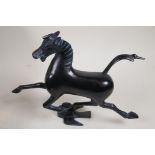 A Chinese bronze Tang style figure of a horse with its foot on the back of a swallow, 6" high