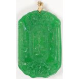 A gold mounted carved jade pendant, 2" long