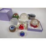 Four glass paperweights, two etched, glass world globes and two Swarovski faceted crystal weights
