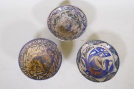 Three middle eastern glazed terracotta bowls with Islamic decoration, 9" diameter