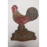 A cast iron door stop in the form of a cockerel