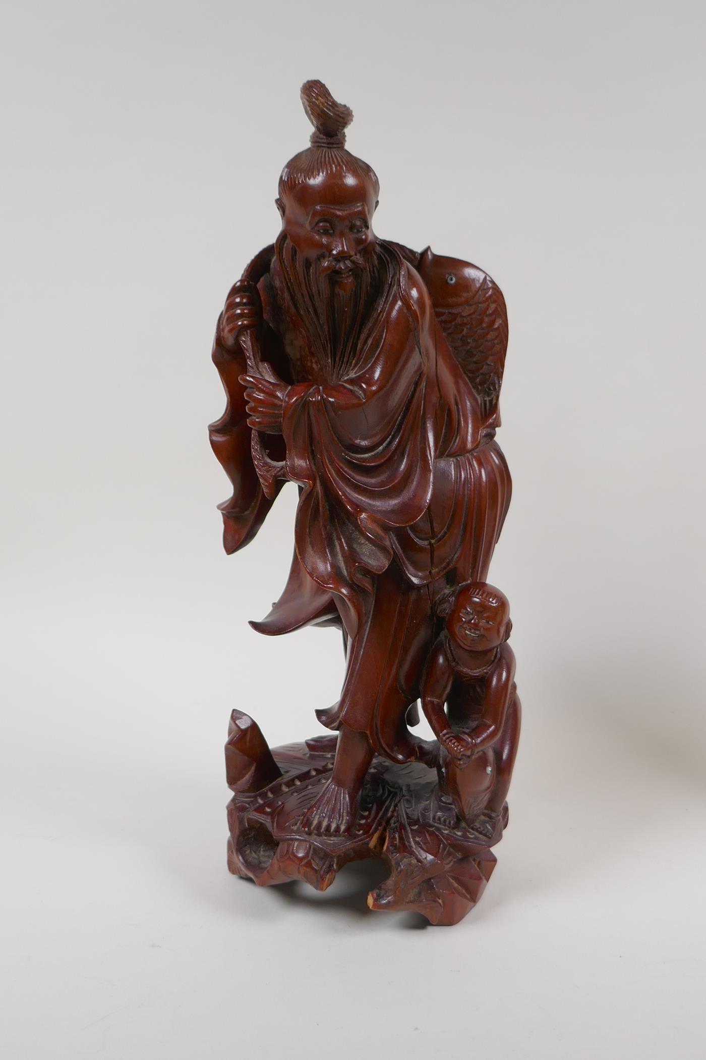A Japanese hardwood carving of a fisherman, and a Balinese hardwood carving of a man in - Image 2 of 6