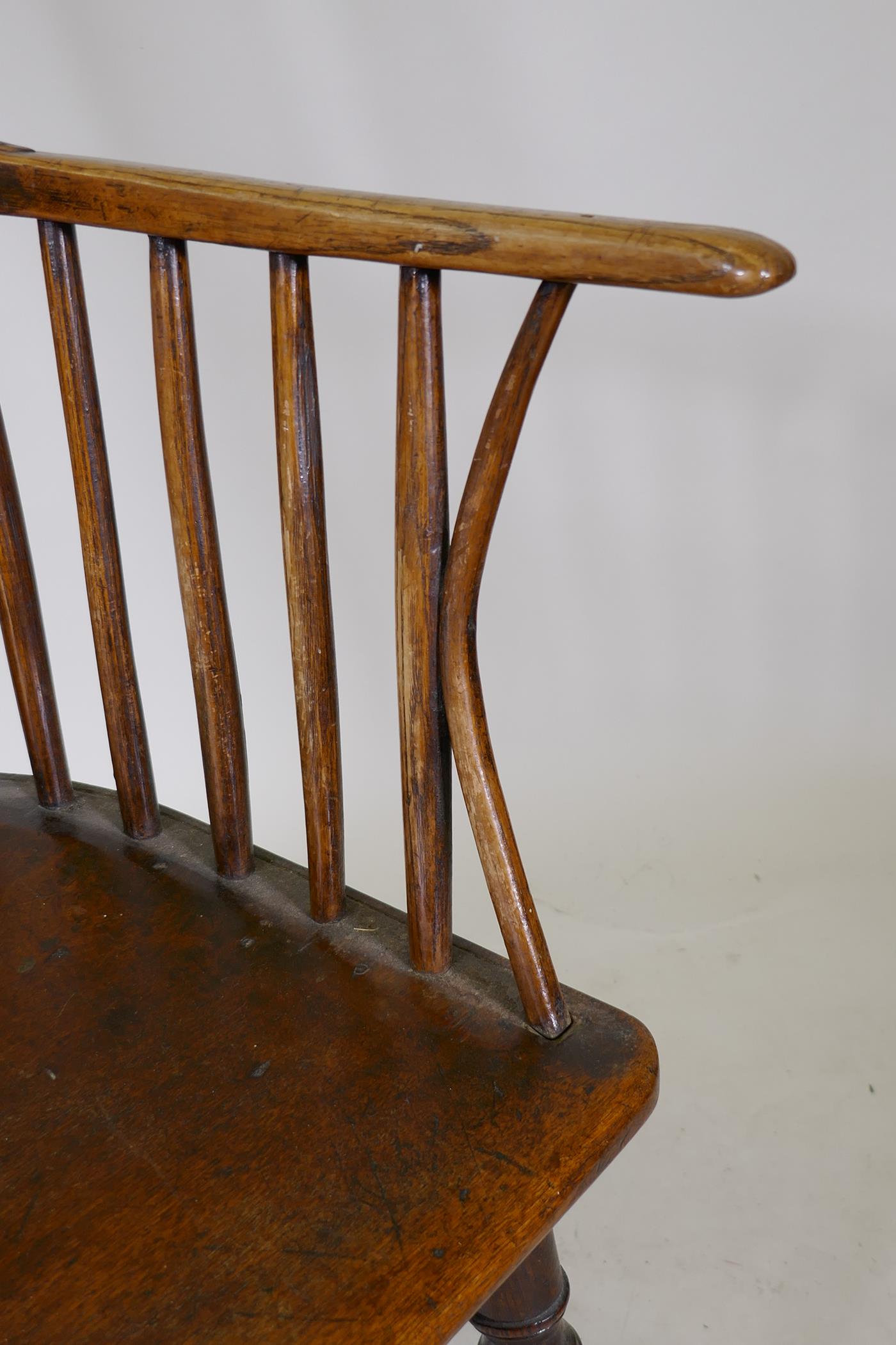 Early C19th Windsor comb back elbow chair with crinoline stretcher, raised on turned supports - Image 5 of 5