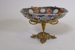 A Meiji Imari octagonal shaped bowl with pierced sides, mounted on an ormolu base, 9½" diameter, 6½"