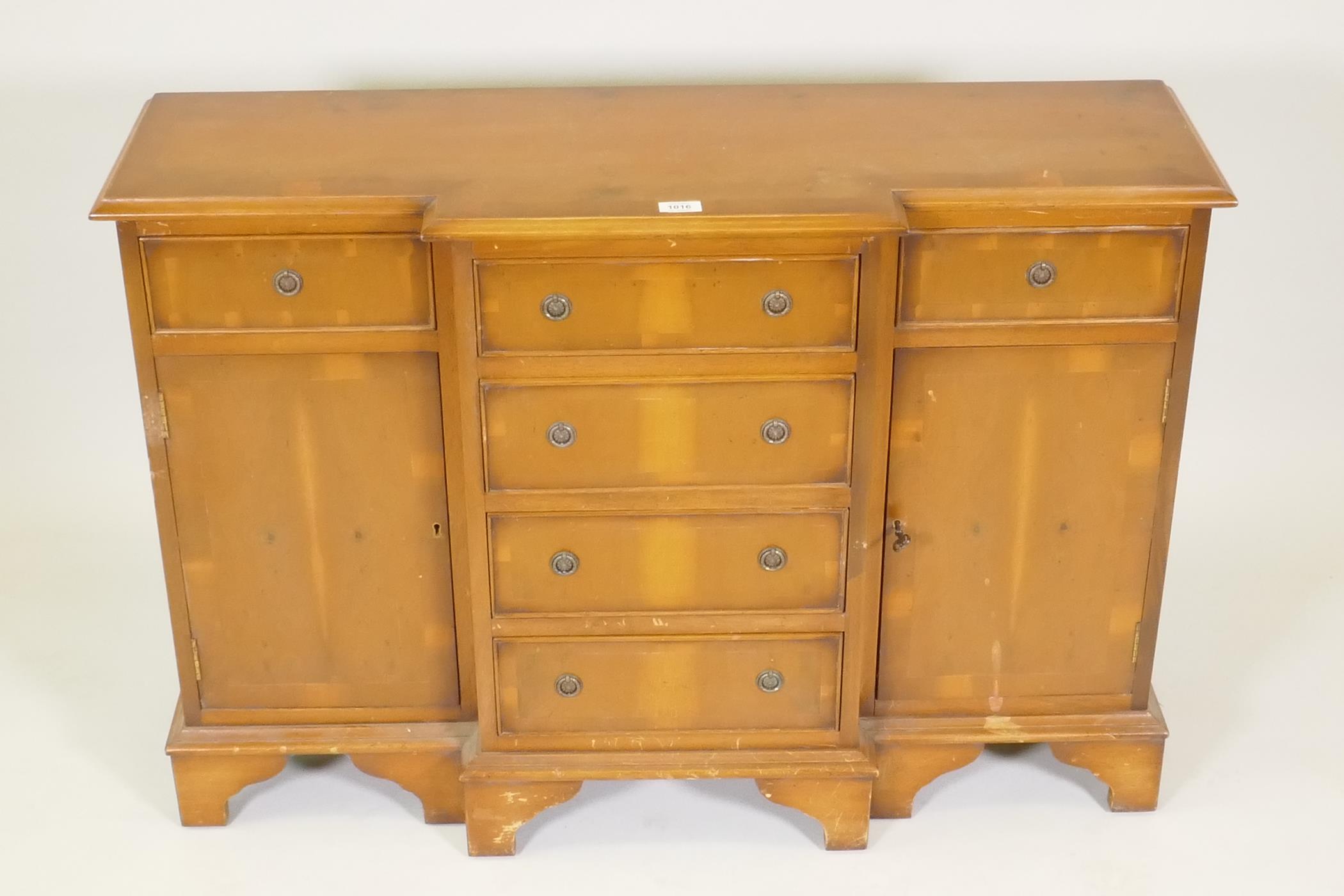 A small yew wood breakfront side cabinet with three drawers over two cupboards flanking a flight - Image 2 of 3