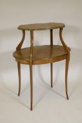 A C19th satinwood two tier occasional table, with cross banded tops, brass mounts and shaped top,