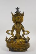 A Sino Tibetan gilt bronze Buddha with four heads, double vajra mark to base, 12" high