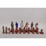 A collection of Indian terracotta figures depicting different trades people, some painted, largest