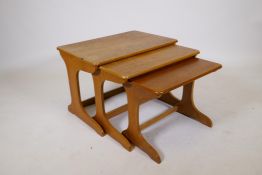 A nest of three mid century teak occasional tables, largest 23½" x 15½", 16½" high