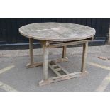 Teak extending garden table with fold out leaf, 47" diameter, 67" extended