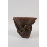 A Chinese faux horn libation cup with carved kylin decoration, seal mark to base, 4" high