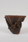 A Chinese faux horn libation cup with carved kylin decoration, seal mark to base, 4" high