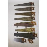 Eight vintage carpenters handsaws with wood handles, largest 30", two with period leather cases