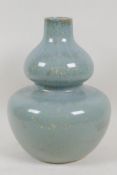 A celadon glazed studio pottery double gourd vase, 10" high