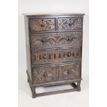 An Ipswich oak chest of drawers with carved drawer fronts and raised on turned supports united by