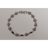 A silver and marcasite set bracelet with flower shape links, 6" long