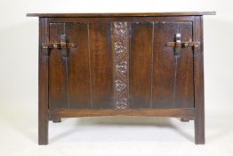 Arts & Crafts oak buffet/sideboard with plank top, tapering sides and two cupboards, one fitted with