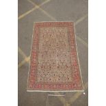 An antique Anatolian Kayseri cream ground wool rug with multi-colour all over floral design, AF wear