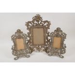 A pair of cast bronze photograph frames, aperture 4" x 2½", and a similar larger frame, 4" x 5½"