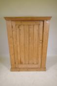 A pine single door cupboard, 43" x 21" x 58"