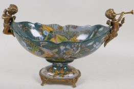 A bronze and porcelain pedestal centrepiece bowl with musical cherub handles, 8" high