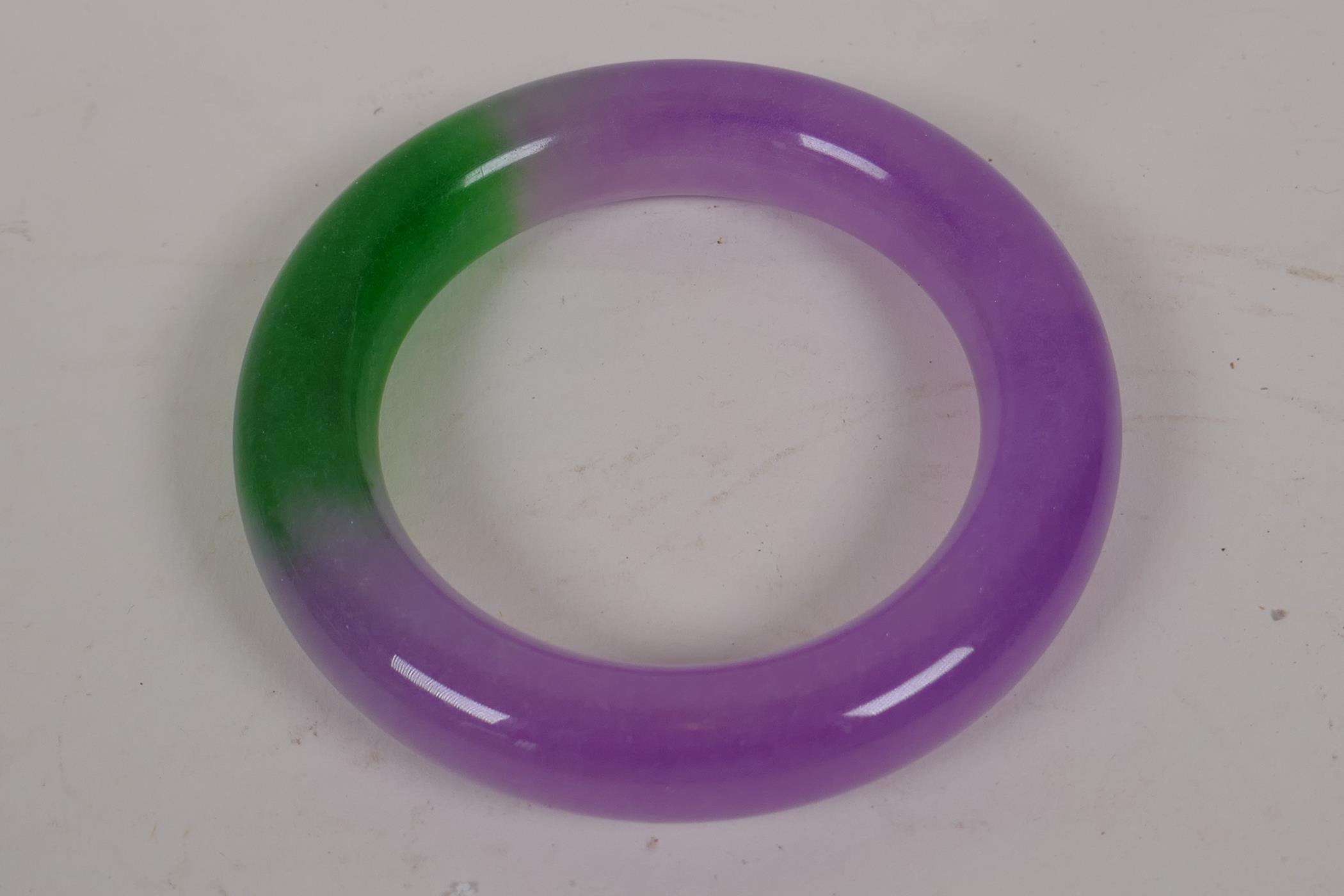 A Chinese lavender and green jade bangle, 3" diameter