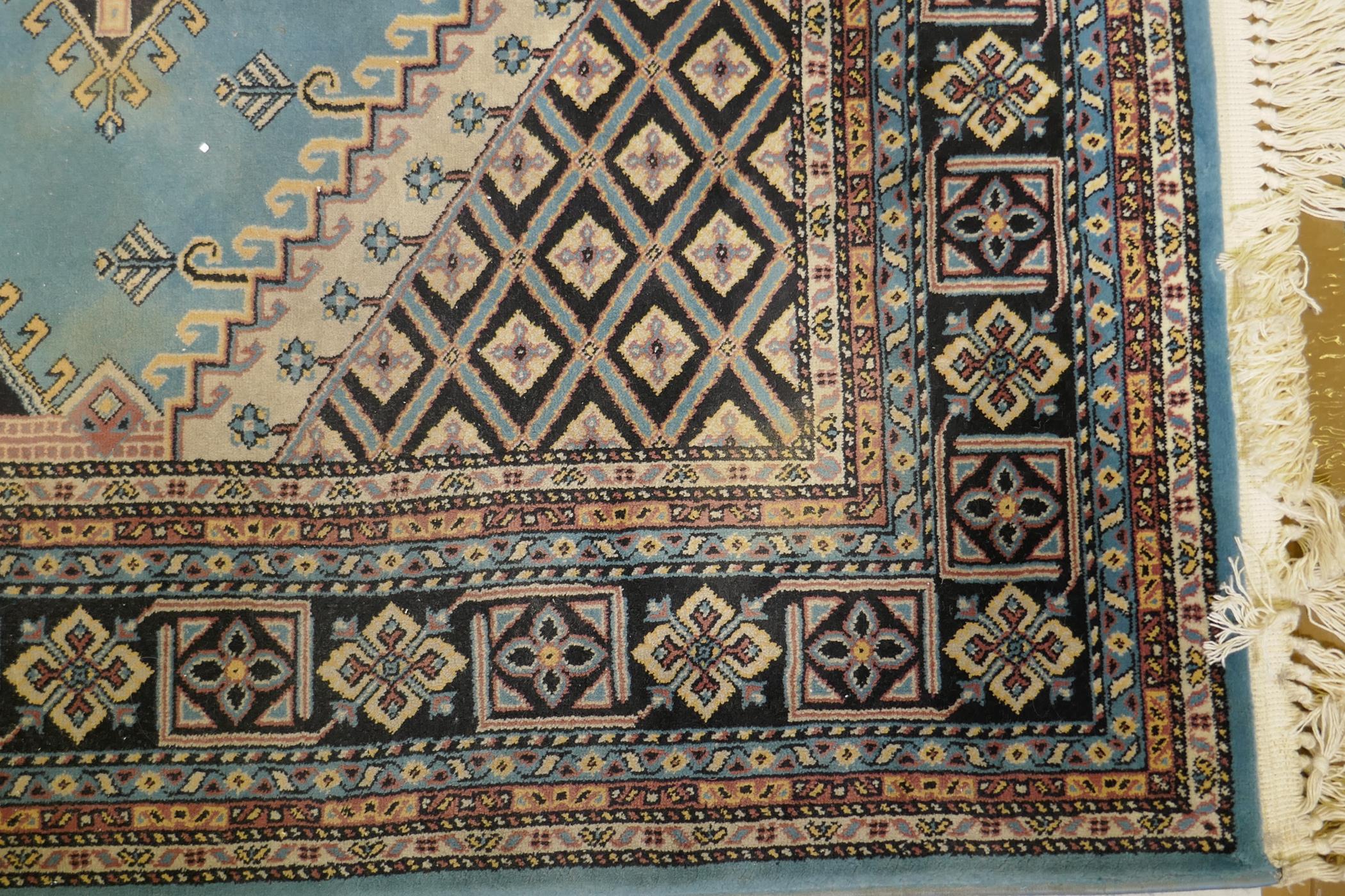 An oriental blue ground wool rug, decorated with a geometric medallion design, 63" x 99" - Image 3 of 4