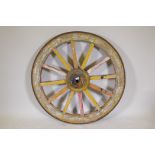 An Indian painted wood and iron bound cartwheel, 47" diameter