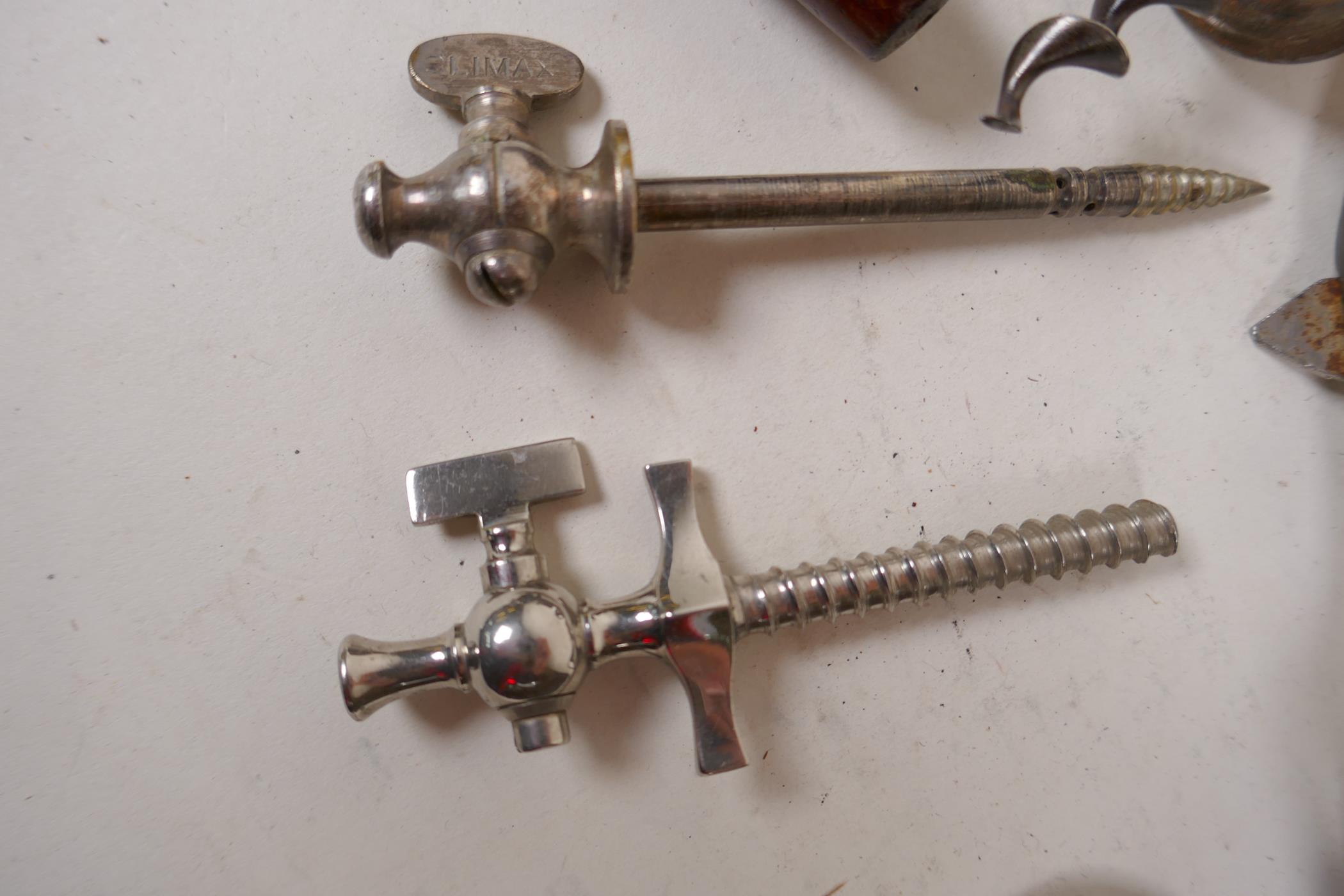 A collection of five antique corkscrews, two champagne taps and a can opener - Image 2 of 4