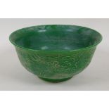 A Chinese green glazed porcelain bowl embossed with dragons, 6 character mark to base, 6" diameter