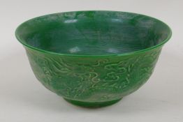 A Chinese green glazed porcelain bowl embossed with dragons, 6 character mark to base, 6" diameter