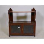 A Victorian mahogany hanging shelf with two glazed doors, 23" x 10" x 26"