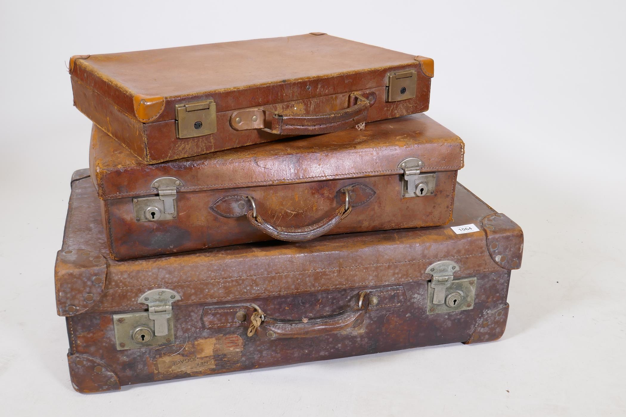 A vintage leather suitcase by R.W. Forsyth, a smaller leather case and an attache case, 26" x 16"