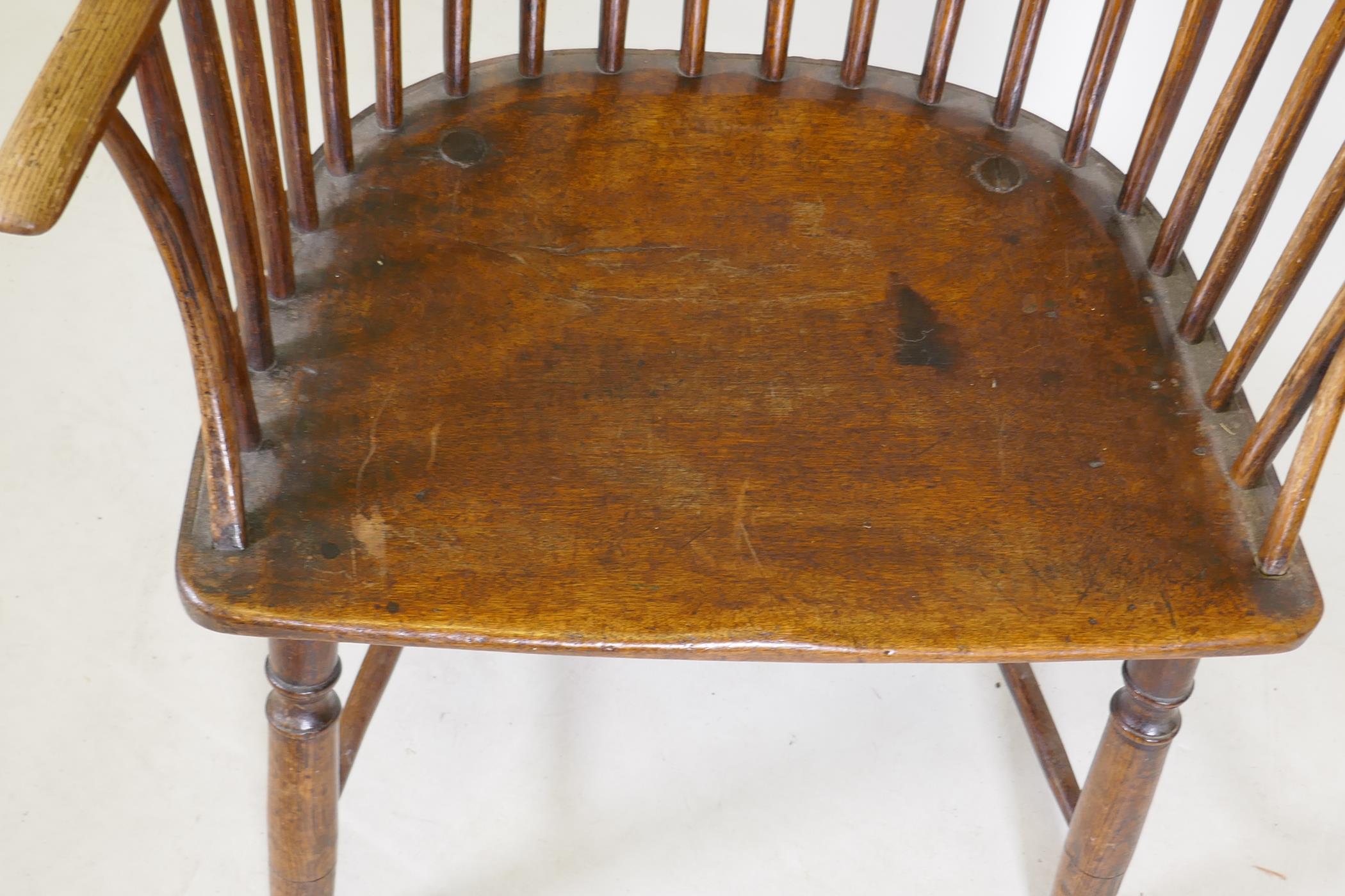 Early C19th Windsor comb back elbow chair with crinoline stretcher, raised on turned supports - Image 2 of 5