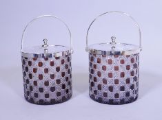 A pair of flash cut ruby glass biscuit barrels with silver plated handles and covers, 6" high