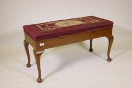 An Essenby mahogany duet stool with woolwork upholstered lift up seat, raised on cabriole