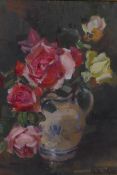 Kate Wylie, roses in a blue and white jug, signed, oil on canvas board, 13½" x 11½"