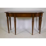 A Georgian style mahogany breakfront serving table, with frieze drawer and raised on fluted
