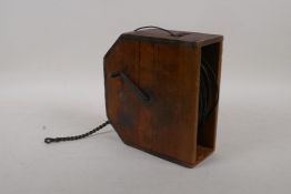 An antique oriental wooden cased tape measure with character markers denoting length, 6½" x 7"