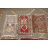 A Persian blue ground wool rug with geometric medallions and stylised birds design, a red ground