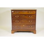 A Georgian mahogany dressing chest of four long drawers, the top with fitted compartments, with