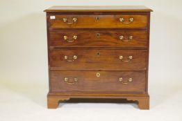 A Georgian mahogany dressing chest of four long drawers, the top with fitted compartments, with