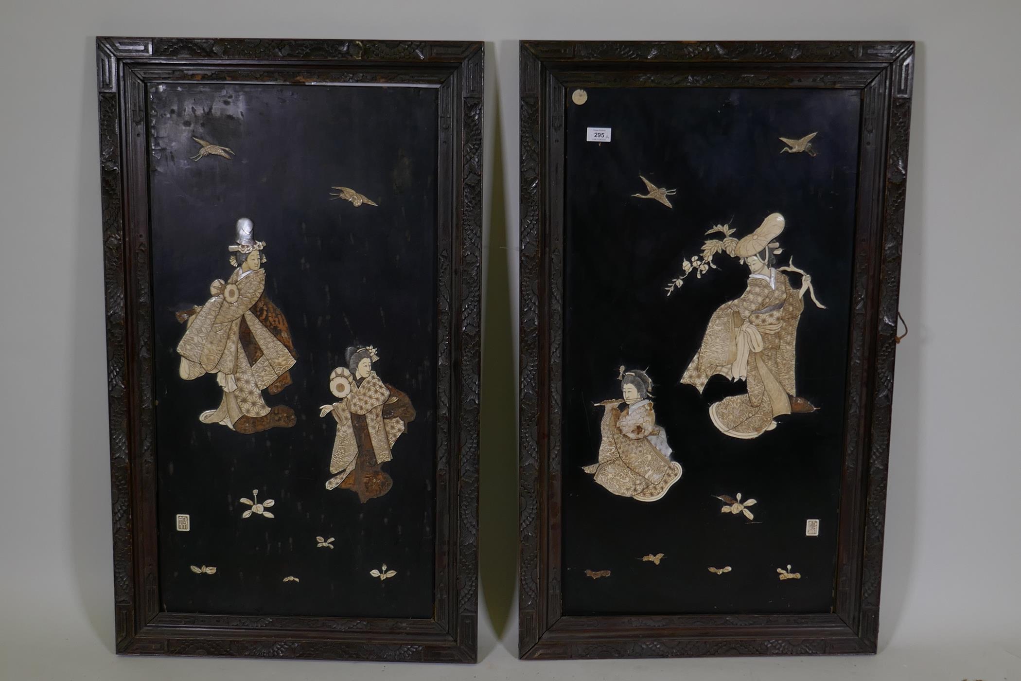 A pair of large Japanese wall plaques with carved and inked ivory decoration of geishas, AF, 25" x