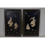 A pair of large Japanese wall plaques with carved and inked ivory decoration of geishas, AF, 25" x