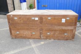 A pine two section bank of drawers, each section of two drawers with cup handles, 76" x 27" x 31"